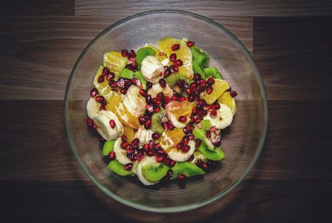 Colorful Fruit Salad Featuring Banana Slices, Kiwi Wedges, Orange Segments and Pomegranate
