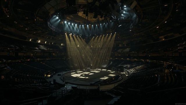 Atmospheric arena stage lit by dramatic spotlight beams