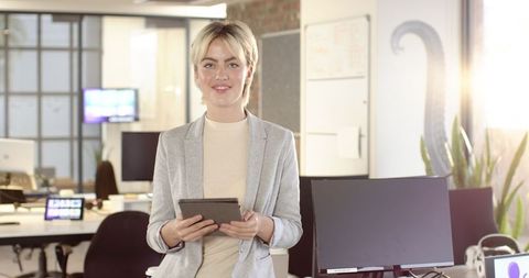 Professional Businesswoman with Tablet in Modern Office Environment