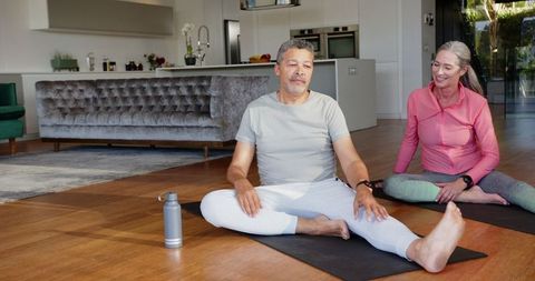 Couple practicing yoga at home, embracing relaxation