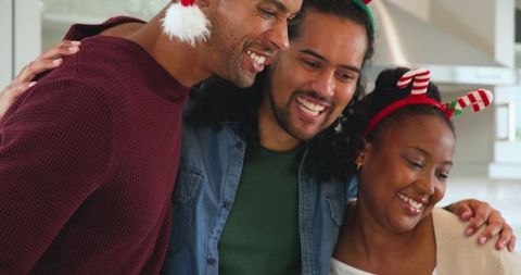 Diverse Friends Celebrating in Christmas Attire in Kitchen