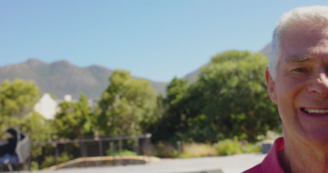 Senior Man Smiling Outdoors with Mountain Scenery - Download Free Stock Images Pikwizard.com