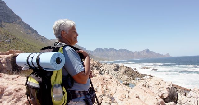 Senior Woman Hiking Along Scenic Coastal Trail with Backpack - Download Free Stock Images Pikwizard.com