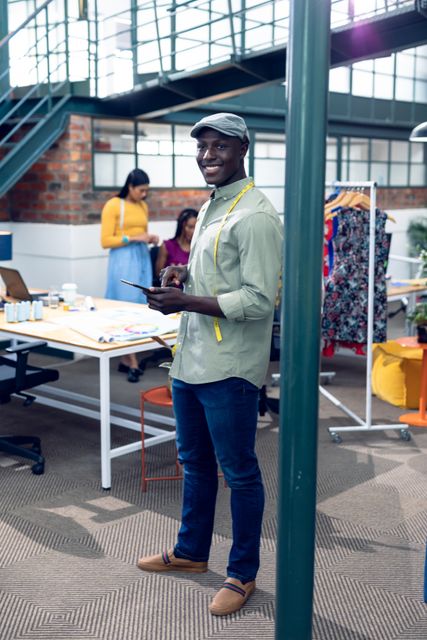 Smiling African American Tailor Using Smartphone in Modern Office - Download Free Stock Images Pikwizard.com