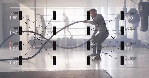 Adult male performing battle rope workout in urban gym with data overlay and copy space