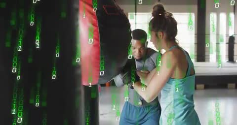 Boxers Training with Punching Bag and Digital Binary Code Overlay