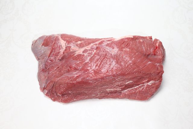 Fresh raw cut of beef presented on a plain white background, perfect for use in culinary blogs, cooking tutorials, food packaging design, restaurant menus or nutritional content. Ideal for emphasizing the quality of fresh meat and ingredients.