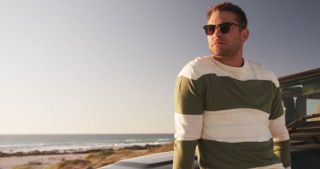 Young Man Relaxing on Beachside with Sunglasses - Download Free Stock Images Pikwizard.com