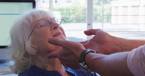 Doctor Examining Elderly Patient in Medical Clinic