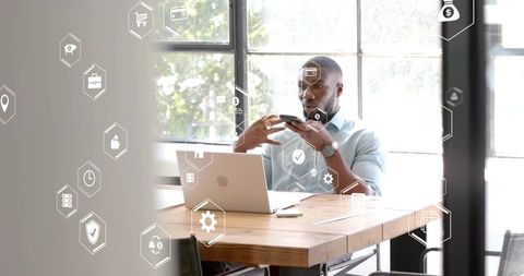 Businessman Analyzing Data with Technology Icons Overlay