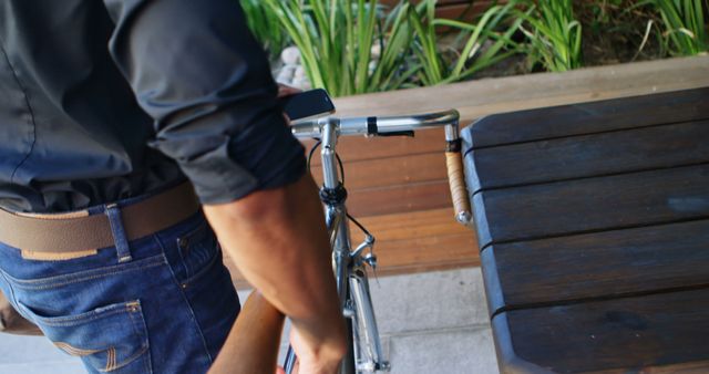 Cyclist Locking Bike Near Outdoor Benches - Download Free Stock Images Pikwizard.com