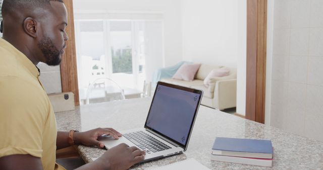 Man Working on Laptop at Home in Bright Living Space - Download Free Stock Images Pikwizard.com