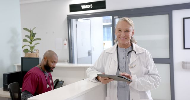 Friendly Doctor and Nurse Working at Hospital Reception - Download Free Stock Images Pikwizard.com