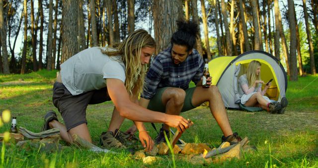 Friends Enjoying Campfire Outdoors at Forest Campsite - Download Free Stock Images Pikwizard.com