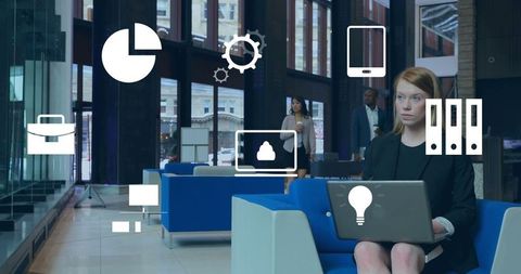 Businesswoman in Modern Office Lounge Analyzing Data on Laptop