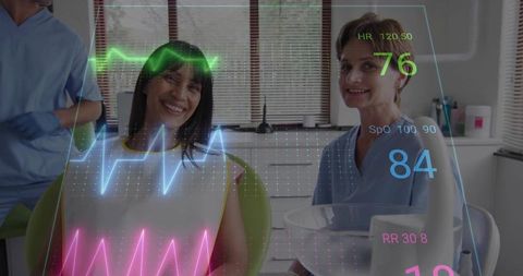 Smiling dental patient receiving futuristic holographic vital monitoring during visit