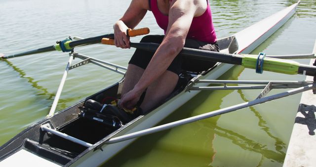 Female Rower in Single Scull Boat Adjusting Foot Straps on Calm Water - Download Free Stock Images Pikwizard.com