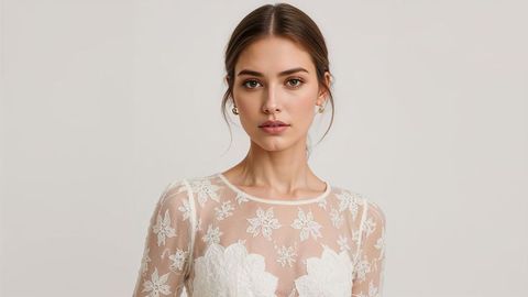 Elegant beautiful lady in intricate floral lace bridal gown