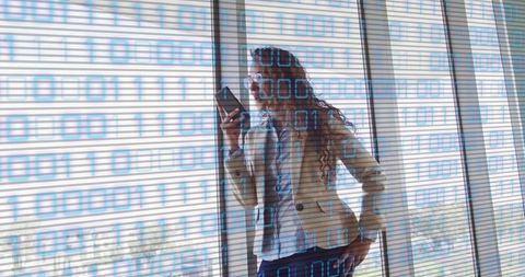 Businesswoman communicating through smartphone with binary code overlay