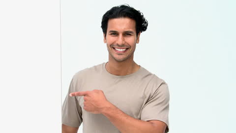 Smiling Man Pointing at Blank White Space for Text