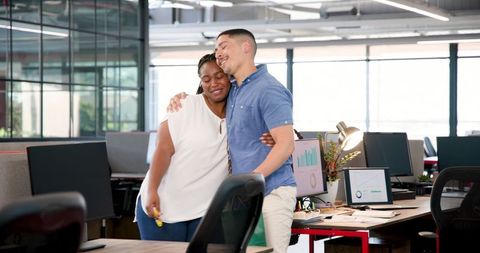 Colleagues Embracing Success in Modern Office