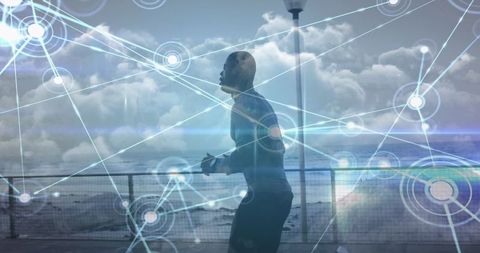 Digital Network Over Exercising Man by Ocean