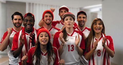 Excited sports fans cheering in red and white jerseys