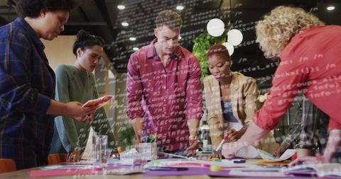 Team Collaborating on Tech Project Overlaid with Data Code