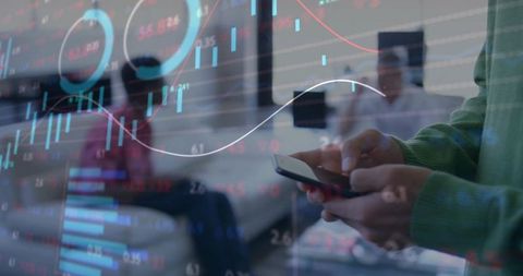 Holding smartphone and viewing financial charts with candlestick graphs in coworking lounge