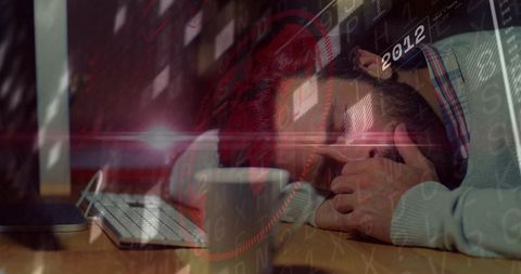 Overworked man resting at desk with hud overlays, keyboard, coffee mug, fatigue concept