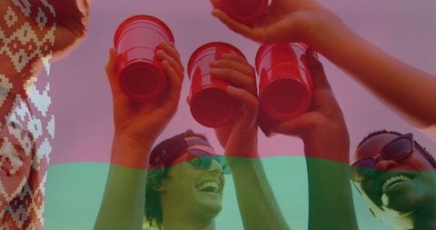 Joyful Friends Celebrating with Red Cups Under the Sun