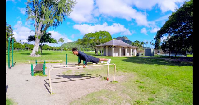 Man Fitness Training Outdoors on Bars in Sunny Park - Download Free Stock Images Pikwizard.com