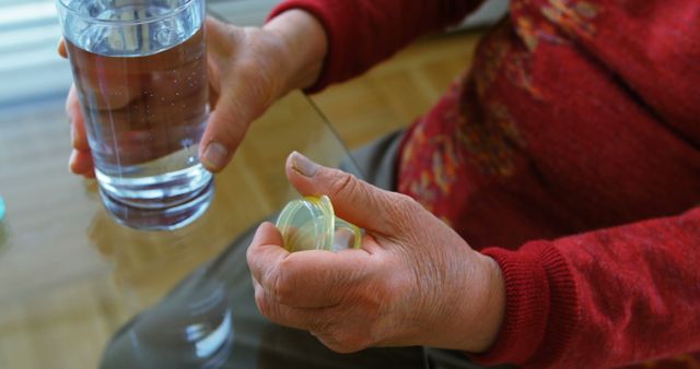 Elderly Person Holding Pill Bottle and Glass of Water - Download Free Stock Images Pikwizard.com