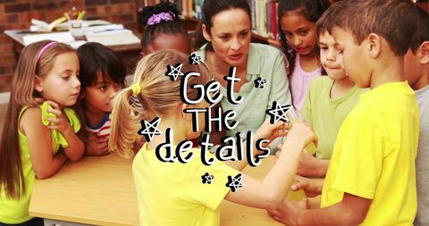 Mature teacher guiding elementary students during hands-on collaborative learning at table