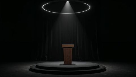Press release spotlight on podium: dramatic theater stage setting