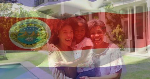 Smiling multigenerational family embracing in backyard pool with costa rica flag overlay