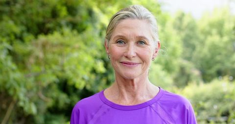 Smiling Senior Woman in Purple Top Outdoors