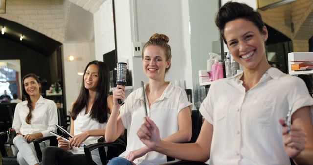 Smiling Women Sitting in Hair Salon Holding Hairdressing Tools - Download Free Stock Images Pikwizard.com