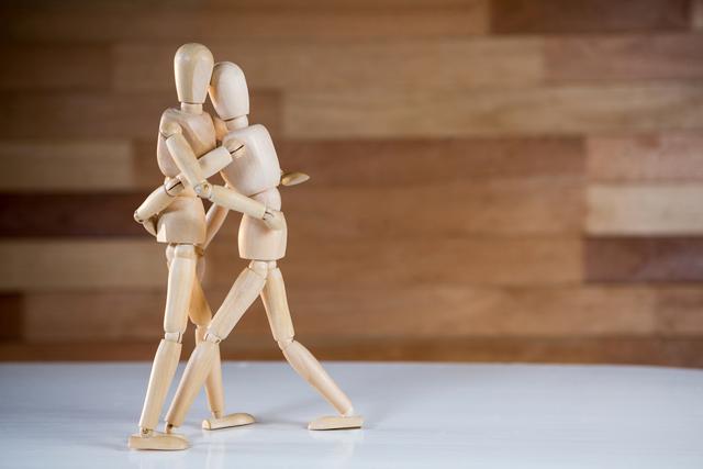 Conceptual image of figurine embracing each other