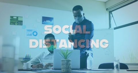 Business team practicing social distancing and safety measures in office