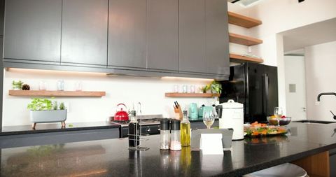 Modern dark countertop kitchen with appliances and decor