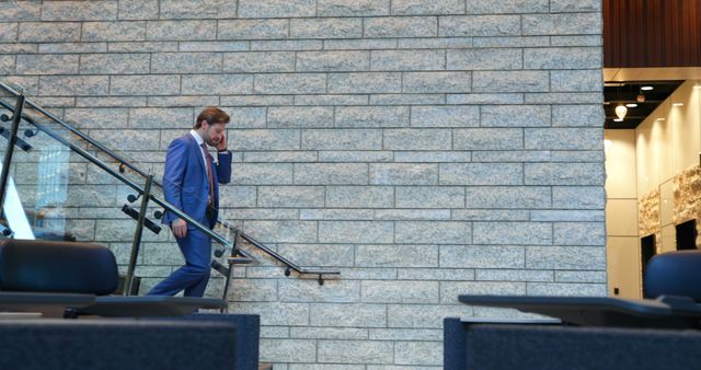 Businessman Walking Down Modern Office Stairs Talking on Phone - Download Free Stock Images Pikwizard.com