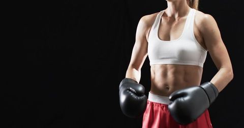 Athletic Woman in Boxing Stance Embracing Power and Focus