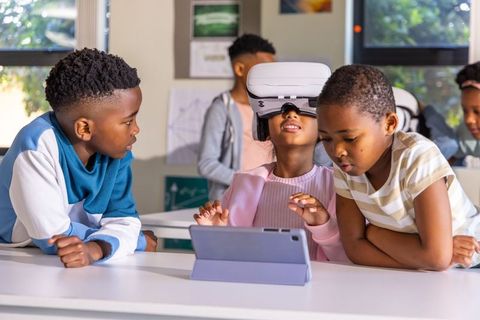 African american kids exploring virtual reality with tablet, collaborative stem learning