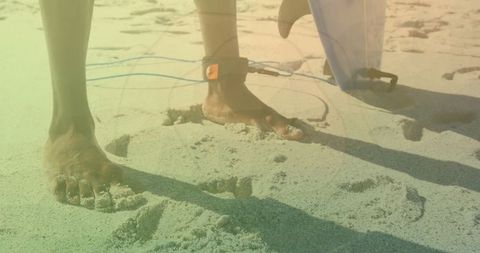 Barefoot Surfer Preparing for Surf on Sunny Beach