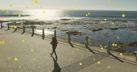 Woman walking along scenic promenade with creative overlay