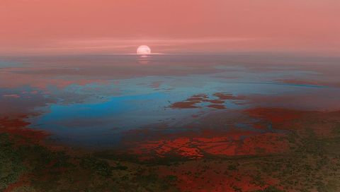 Glowing sun reflecting across tidal marsh at sunrise with coral and teal gradient