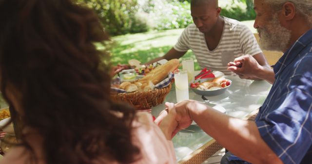 Family Praying Before Meal in Outdoor Garden Setting - Download Free Stock Images Pikwizard.com