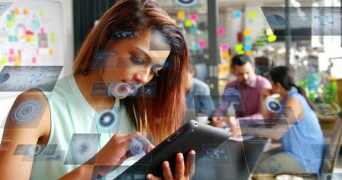 Woman using tablet interacting with holographic user interface in coworking office