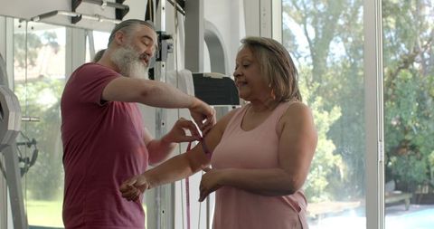 Senior Couple Exercising with Resistance Bands in Gym